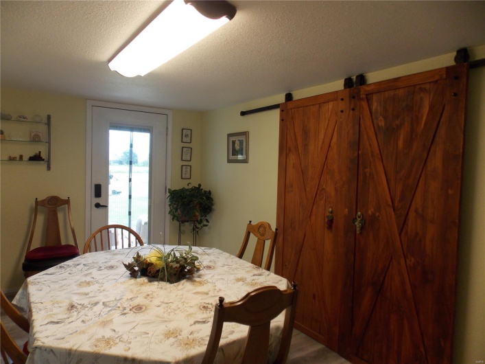 Dining space featuring a barn door and a textured ceiling
