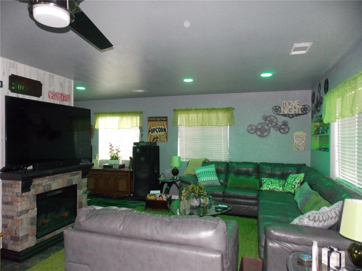 Living area featuring recessed lighting, a fireplace, and visible vents