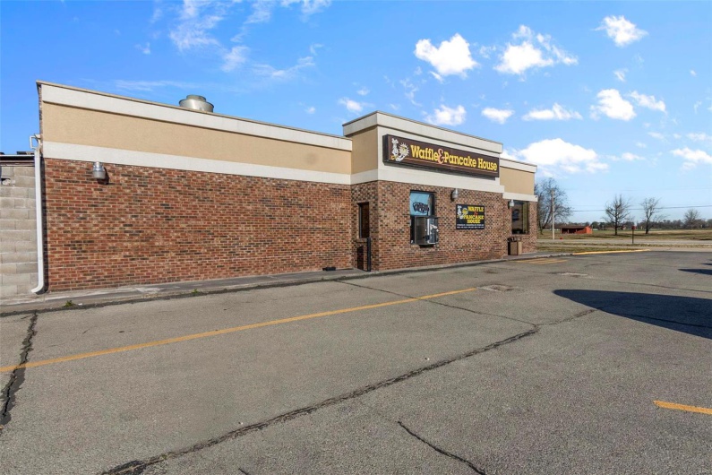 View of property with uncovered parking