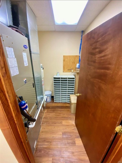 Bathroom featuring toilet, a paneled ceiling, and wood finished floors