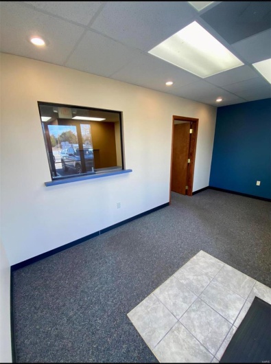 Carpeted spare room with a drop ceiling, recessed lighting, and baseboards