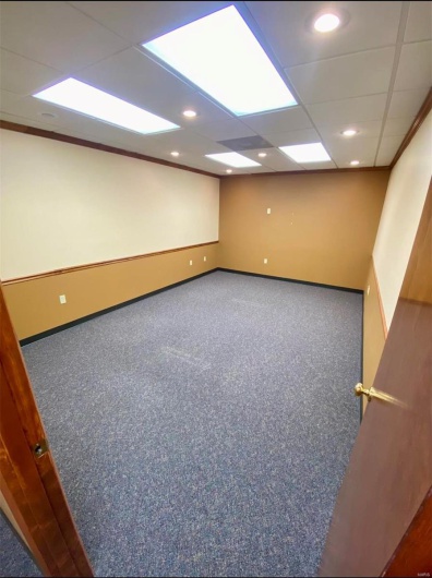 Carpeted spare room with recessed lighting, baseboards, and a drop ceiling