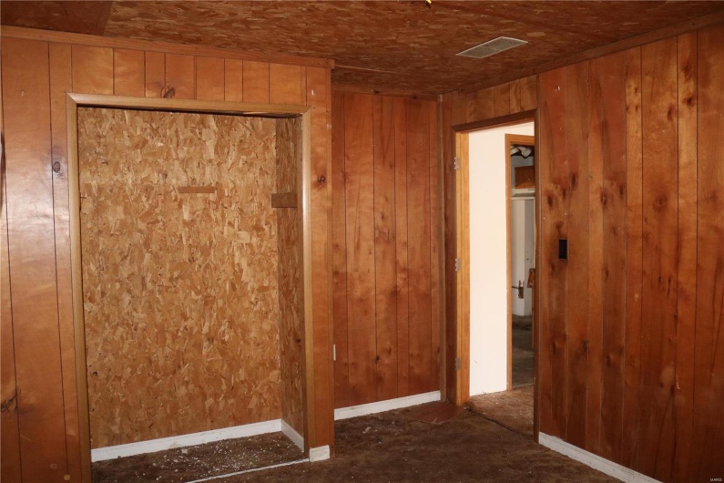 Downstairs Bedroom #2  featuring wooden walls
