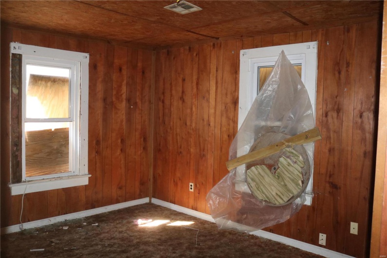 Downstairs Bedroom #2  featuring wooden walls