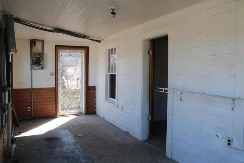 Unfurnished sunroom featuring wood ceiling and a healthy amount of sunlight
