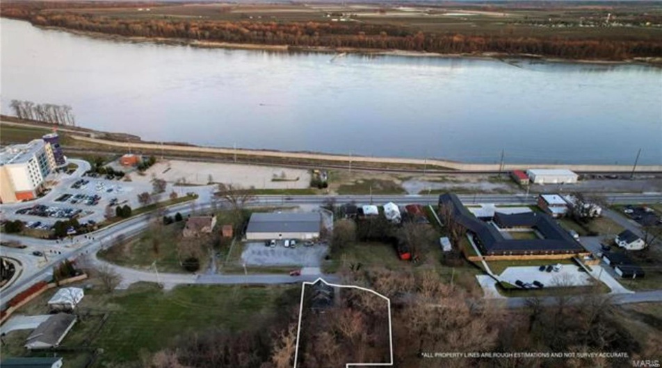 Birds eye view of property with a water view