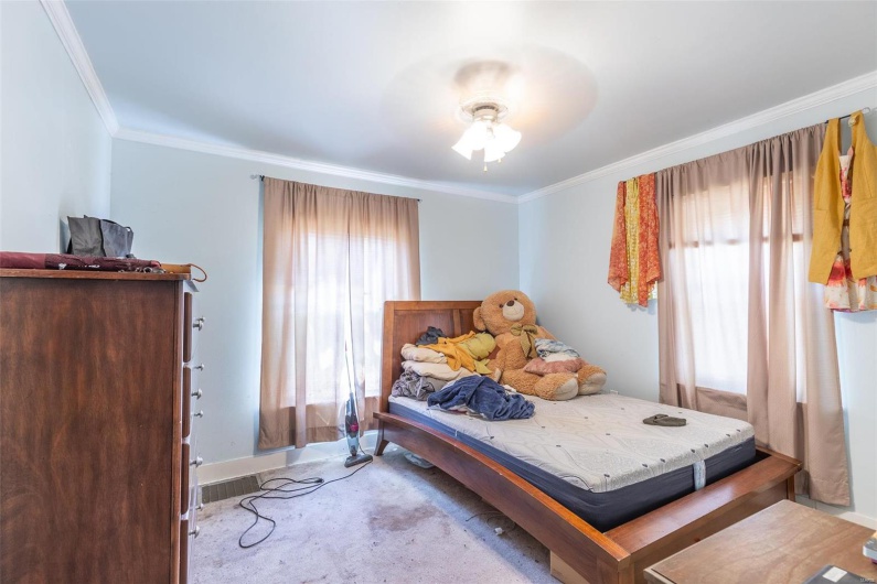 Bedroom featuring ceiling fan, baseboards, and ornamental molding