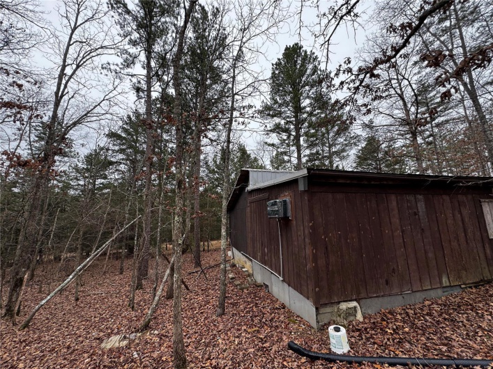 View of side of property with metal roof and an outbuilding