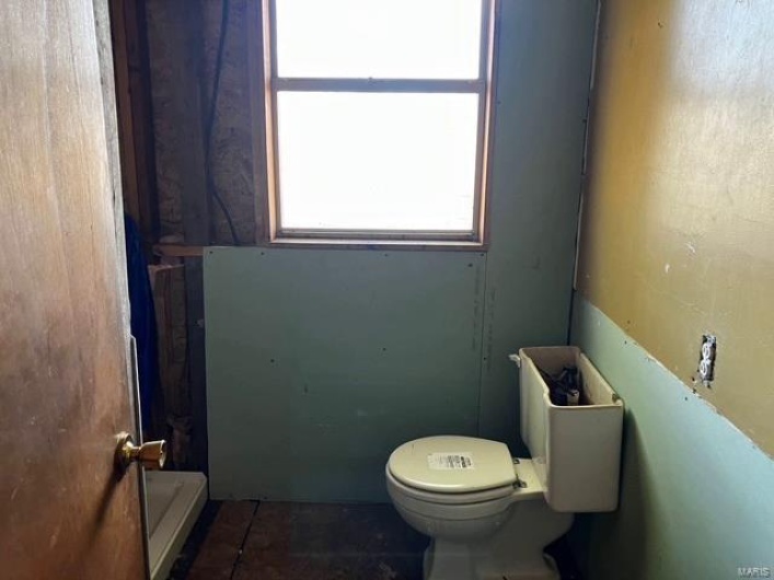Bathroom featuring tile patterned floors and toilet