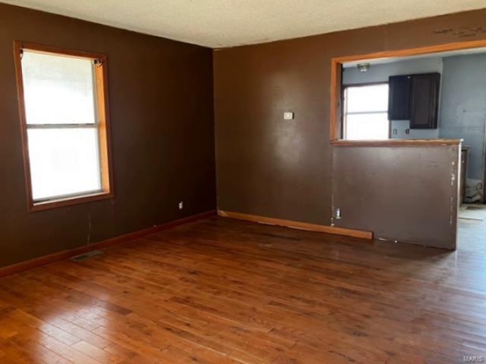 Empty room featuring baseboards and wood finished floors