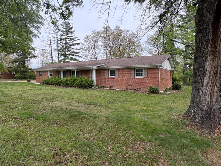 Ranch-style house with a front lawn and brick siding