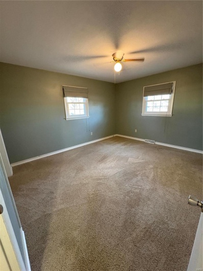 Unfurnished room with carpet and a textured ceiling