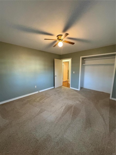 Unfurnished bedroom with carpet flooring, a closet, and ceiling fan
