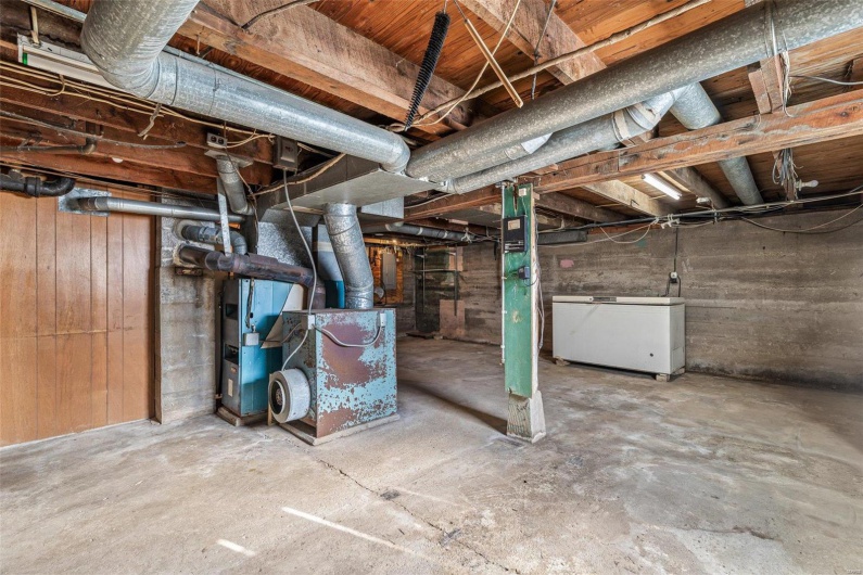 Unfinished below grade area featuring fridge
