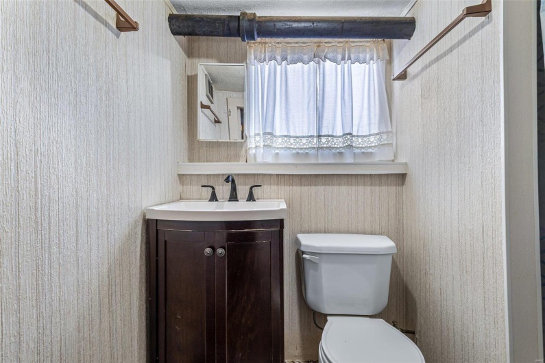 Half bathroom with vanity and toilet