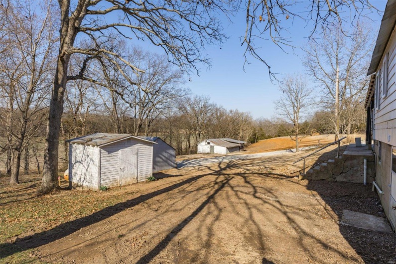 View of yard with a storage shed and an outdoor structure