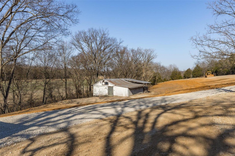 View of yard featuring an outdoor structure and a pole building
