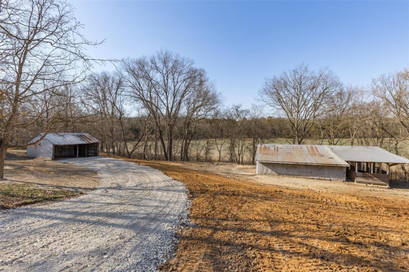 View of road featuring an outbuilding and driveway