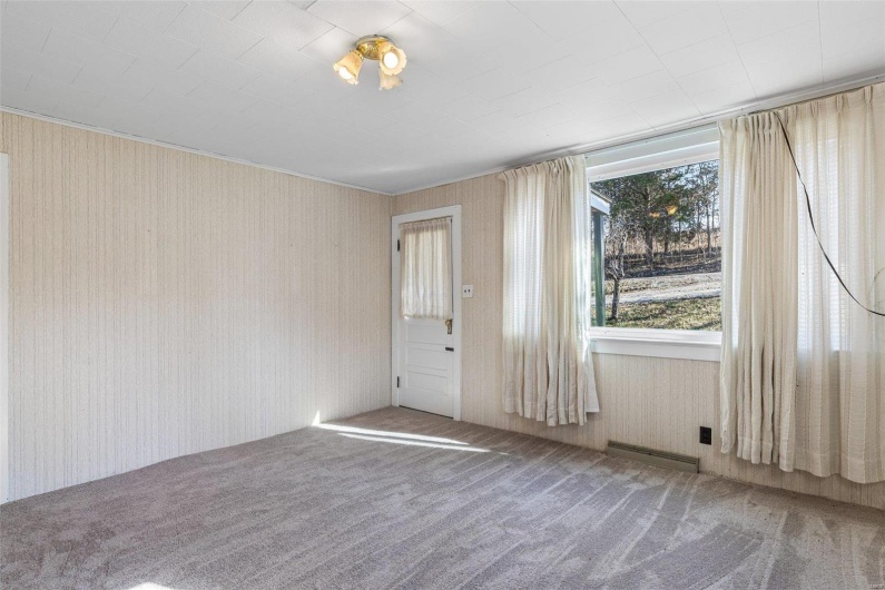 Spare room featuring carpet flooring and visible vents
