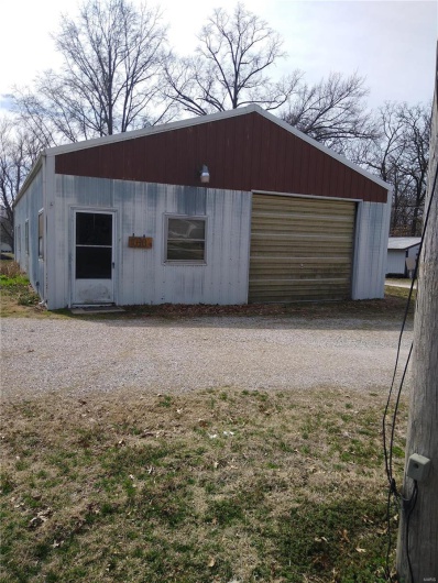 View of outbuilding with an outdoor structure and driveway