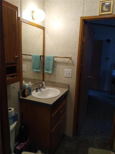 Half bathroom with vanity and toilet