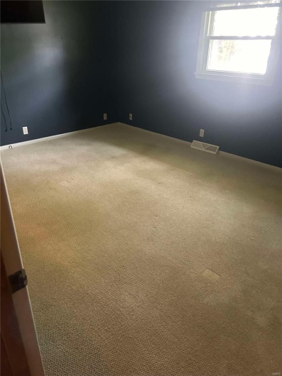 Unfurnished room with visible vents and carpet flooring