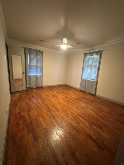 Unfurnished room with ceiling fan, baseboards, ornamental molding, and hardwood / wood-style flooring
