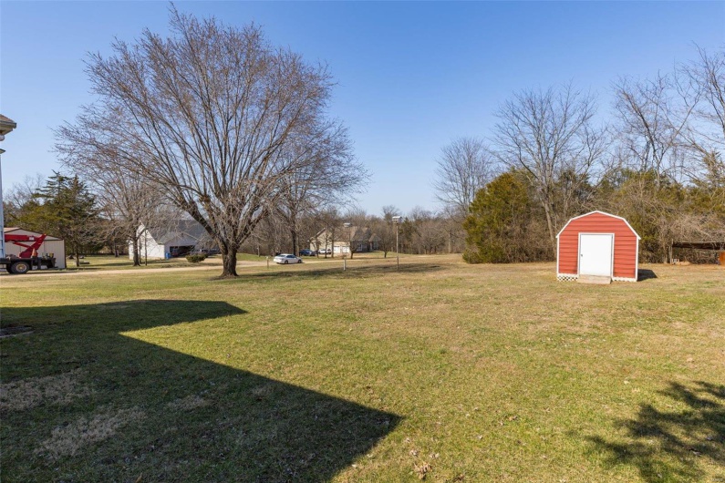 View of yard with an outdoor. Shed does not stay