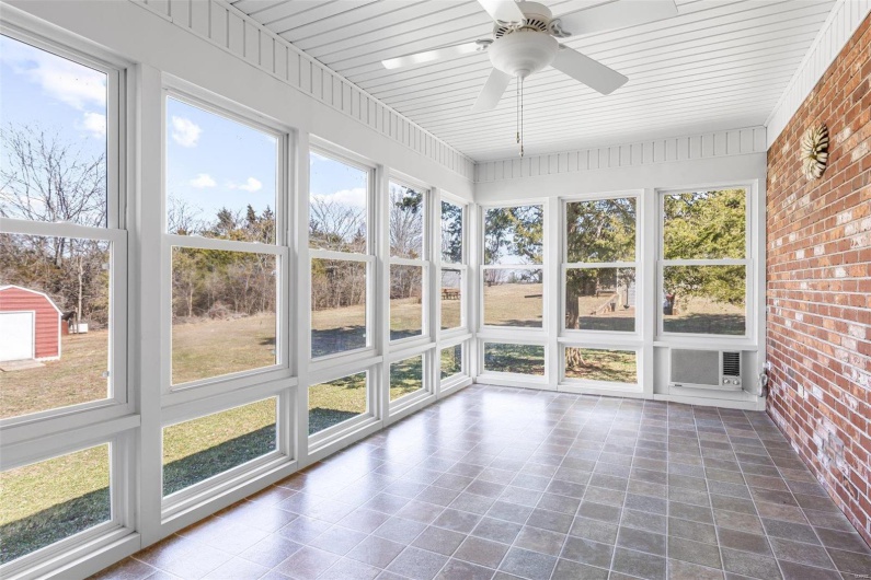 Unfurnished sunroom with a ceiling fan