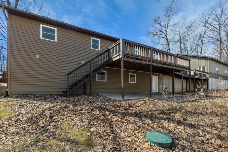 Back of property featuring a patio, stairway, and a wooden deck