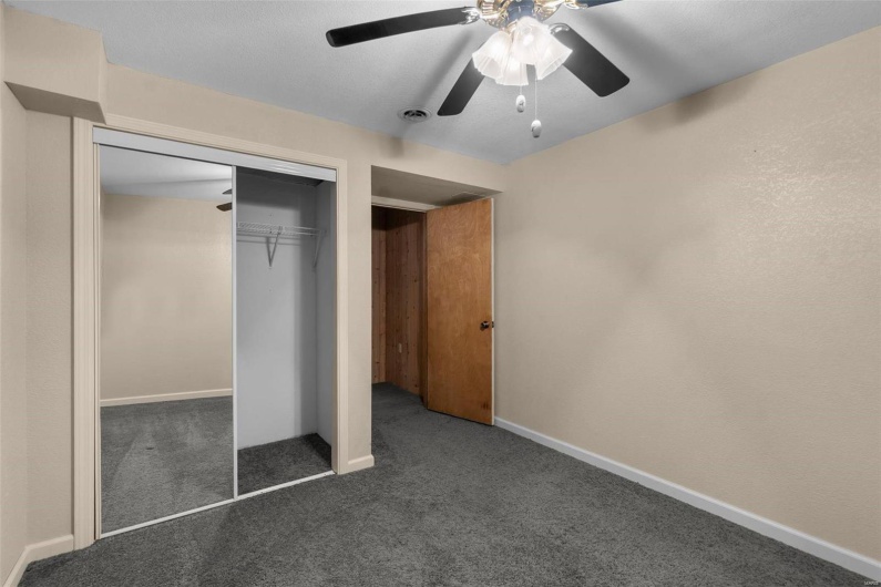 Unfurnished bedroom featuring visible vents, a ceiling fan, a closet, carpet flooring, and baseboards