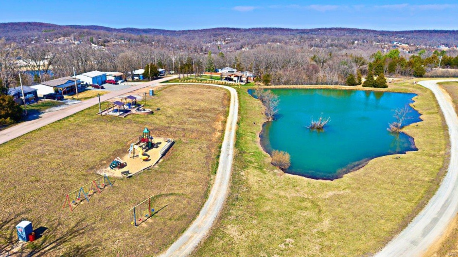 Drone / aerial view featuring a forest view and a water view