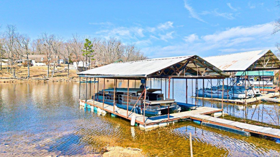 View of dock with boat lift and a water view