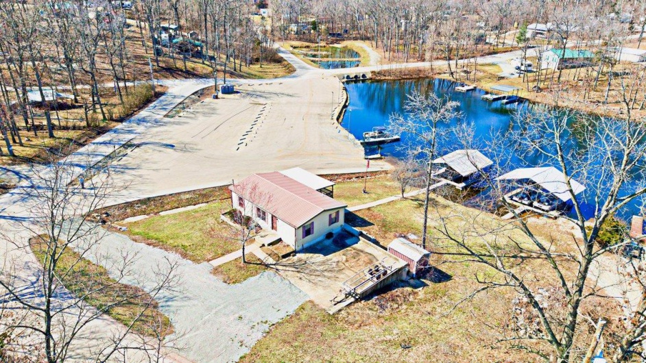Birds eye view of property with a water view