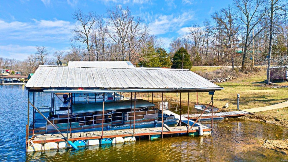 Dock area with boat lift and a water view