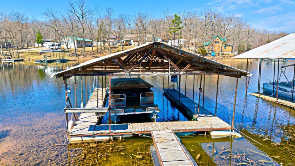 Dock area with a water view and boat lift