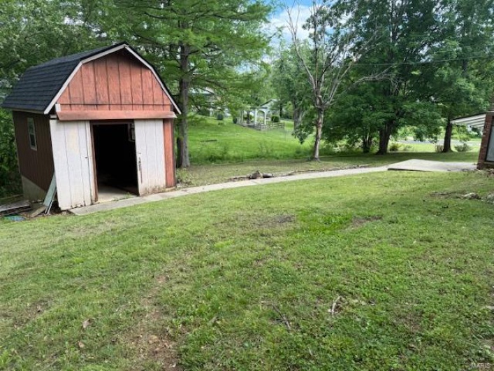 View of yard with a shed and an outdoor structure