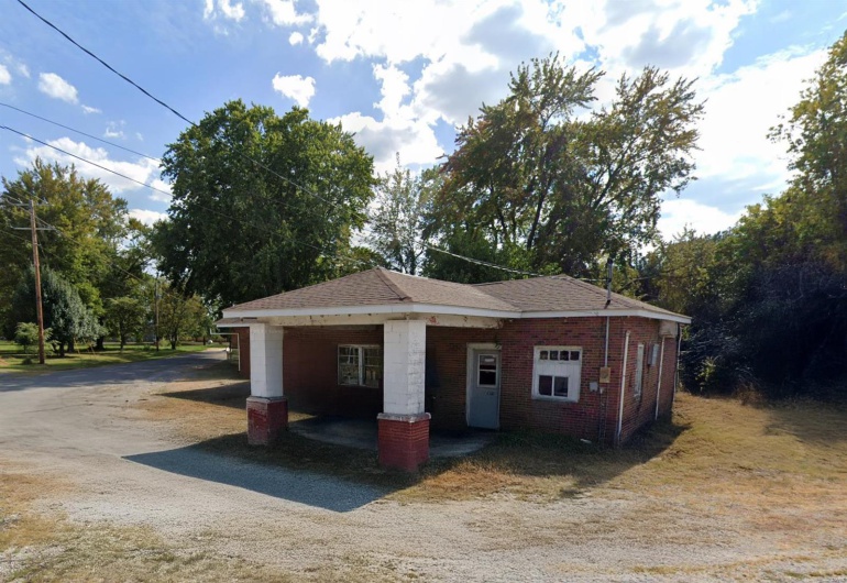Garage with an attached carport and driveway