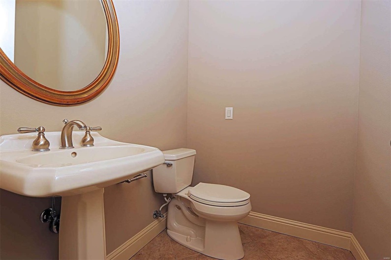 Bathroom with toilet and tile patterned floors