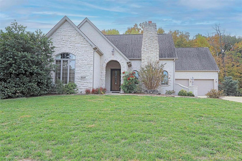 View of front of home featuring a garage and a front lawn