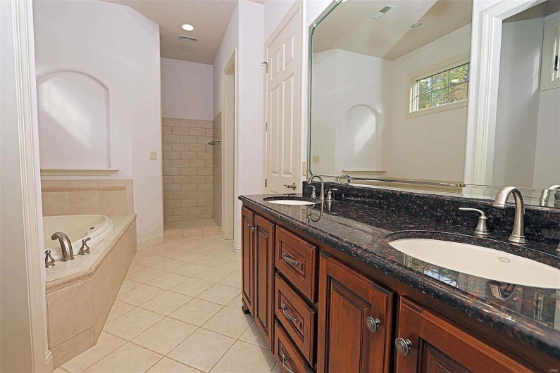 Bathroom featuring vanity, separate shower and tub, and tile patterned flooring