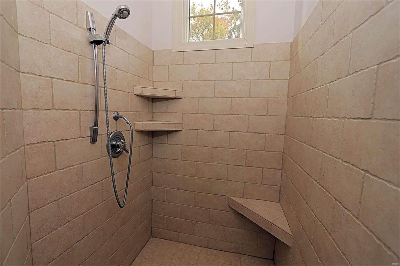 Bathroom featuring a tile shower