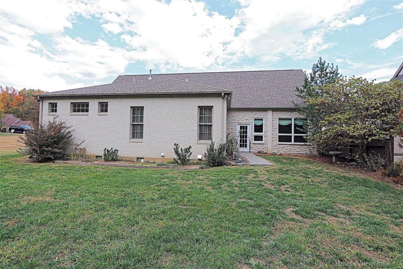 Rear view of property with a patio area and a lawn
