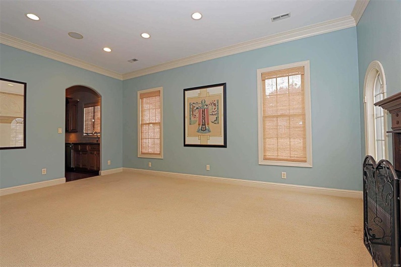 Empty room featuring crown molding and light colored carpet