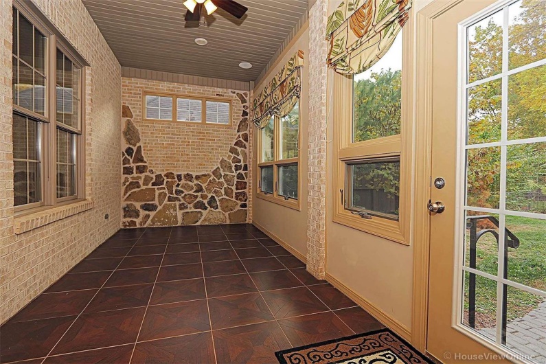 Unfurnished sunroom featuring a healthy amount of sunlight and ceiling fan