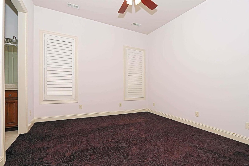 Unfurnished room featuring carpet and ceiling fan