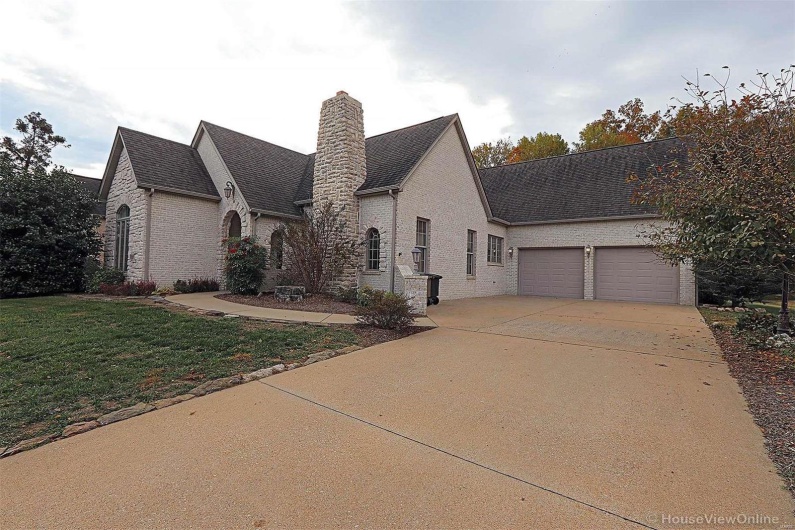 French country style house featuring a front yard and a garage