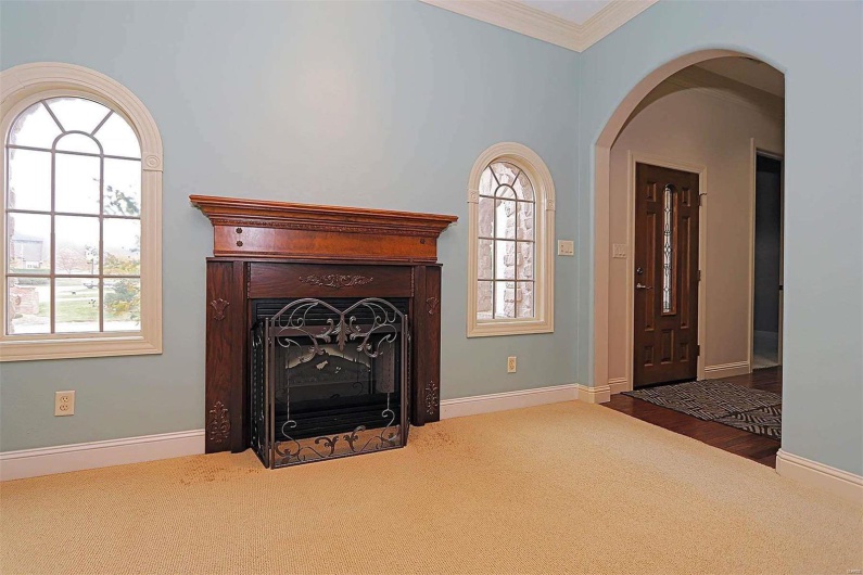 Unfurnished living room with ornamental molding and wood-type flooring