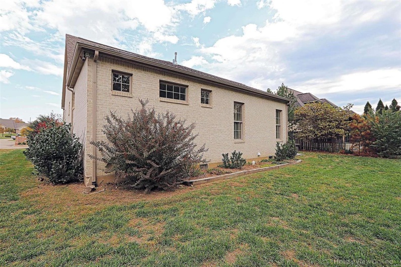 View of side of property featuring a yard
