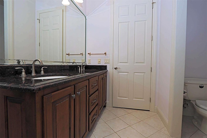 Bathroom with vanity, toilet, and tile patterned floors